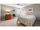 Cozy bedroom with neutral tones, a ceiling fan, and shuttered windows at 7300 Wax Myrtle Way, Sarasota, FL 34241