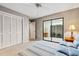 This bedroom features a ceiling fan, closet and sliding doors to the lanai at 7300 Wax Myrtle Way, Sarasota, FL 34241