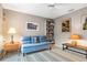 Cozy bedroom with a blue futon, soft lighting, and decor at 7300 Wax Myrtle Way, Sarasota, FL 34241