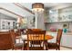 Cozy dining area featuring a wooden table, comfortable chairs, and a view of the living room at 7300 Wax Myrtle Way, Sarasota, FL 34241