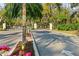 This community has an elegant entry gate with palm trees and lush landscaping at 7300 Wax Myrtle Way, Sarasota, FL 34241