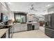 Bright open concept kitchen with stone fireplace and connecting living space, ideal for modern living at 7300 Wax Myrtle Way, Sarasota, FL 34241