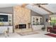 Living room featuring stone fireplace, vaulted ceilings with exposed beams, and built-in shelves at 7300 Wax Myrtle Way, Sarasota, FL 34241