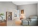 Inviting living room with a comfortable chair, bookshelf, and neutral decor at 7300 Wax Myrtle Way, Sarasota, FL 34241