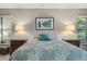 Cozy main bedroom featuring a decorative bed and side tables with lamps at 7300 Wax Myrtle Way, Sarasota, FL 34241