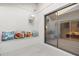 Bright patio with a wall-mounted vintage television and glass sliding door at 7300 Wax Myrtle Way, Sarasota, FL 34241