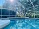 The refreshing pool features a screened lanai with views of landscaped grounds at 7300 Wax Myrtle Way, Sarasota, FL 34241