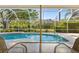 Screened in pool with view of backyard at 7300 Wax Myrtle Way, Sarasota, FL 34241