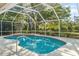 Enclosed pool featuring a screened enclosure and mature trees for a peaceful and shaded swimming experience at 7300 Wax Myrtle Way, Sarasota, FL 34241
