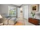 Relaxing sitting room features a comfortable armchair, shuttered window, and a decorative painting at 7300 Wax Myrtle Way, Sarasota, FL 34241