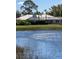 Back of home overlooking waterfront view and screened lanai at 7300 Wax Myrtle Way, Sarasota, FL 34241