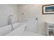 Modern bathroom featuring a luxurious soaking tub and stylish white tile at 7330 Westmoreland Dr, Sarasota, FL 34243