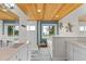 Bright bathroom featuring wood ceilings, dual vanity sinks, a standalone shower and soaking tub at 7330 Westmoreland Dr, Sarasota, FL 34243