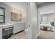Elegant bathroom featuring a vanity area, framed mirror, modern toilet, and a bedroom view at 7330 Westmoreland Dr, Sarasota, FL 34243