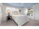 Cozy bedroom with blue ceiling, white walls, a large window and a comfortable bed at 7330 Westmoreland Dr, Sarasota, FL 34243