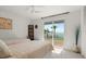 Tranquil bedroom featuring two twin beds, sliding glass doors with water view, and neutral tones at 7330 Westmoreland Dr, Sarasota, FL 34243