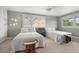 Bright bedroom featuring two twin beds, natural light, and a charming accent table at 7330 Westmoreland Dr, Sarasota, FL 34243