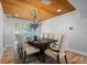 Elegant dining room with wood-look tile flooring, chandelier, and seating for eight around a dark wood table at 7330 Westmoreland Dr, Sarasota, FL 34243