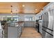 Modern kitchen featuring stainless steel appliances, wood-look floors, and granite countertops with water views at 7330 Westmoreland Dr, Sarasota, FL 34243