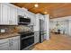 Modern kitchen features stainless steel appliances, granite countertops, and adjacent dining area at 7330 Westmoreland Dr, Sarasota, FL 34243