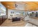 Spacious living room with a wooden ceiling offering views of the outdoor space and open to the kitchen at 7330 Westmoreland Dr, Sarasota, FL 34243