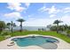 Beautiful pool area with a spa, surrounded by lush tropical landscaping and waterfront at 7330 Westmoreland Dr, Sarasota, FL 34243