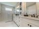 Modern bathroom with dual sinks, white cabinetry, and a glass-enclosed shower, offering a clean and luxurious aesthetic at 7561 Nighthawk Dr, Sarasota, FL 34241