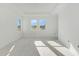 Bright bedroom with large windows offering an abundance of natural light and a tray ceiling at 7561 Nighthawk Dr, Sarasota, FL 34241
