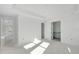 Bright bedroom featuring tray ceiling, ensuite bathroom, and an open doorway at 7561 Nighthawk Dr, Sarasota, FL 34241
