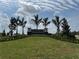 Welcoming monument sign surrounded by lush landscaping and palm trees, marking the entrance to Hawkstone at 7561 Nighthawk Dr, Sarasota, FL 34241