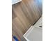 Close-up of new wood-look flooring and white trim, showcasing durability and stylish design at 7561 Nighthawk Dr, Sarasota, FL 34241