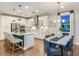 Bright, modern kitchen with white cabinets, stainless steel appliances, marble countertops and a dining area at 7561 Nighthawk Dr, Sarasota, FL 34241