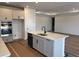 Well-lit kitchen boasting a spacious island with a sink and modern fixtures and stainless steel appliances at 7561 Nighthawk Dr, Sarasota, FL 34241