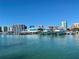 Waterfront view showcasing luxury yachts docked in front of modern city buildings at 7561 Nighthawk Dr, Sarasota, FL 34241