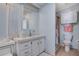 Bathroom with a shower, toilet, sink, and cabinet at 759 Lakeside Dr, North Port, FL 34287