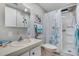 Bright bathroom featuring a shower, white vanity, and tropical-themed decor creating a cheerful atmosphere at 759 Lakeside Dr, North Port, FL 34287