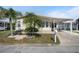 Well-maintained home with a covered carport and lush landscaping, enhancing its curb appeal at 759 Lakeside Dr, North Port, FL 34287