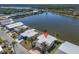 Waterfront home featuring mature palms and carport in a tranquil coastal setting near a scenic lake at 772 Imperial Dr, North Port, FL 34287
