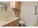 Bathroom featuring a vanity with a sink and a shower with floral wallpaper at 772 Imperial Dr, North Port, FL 34287