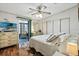 The main bedroom gives access to the Florida room, and has wood-look flooring at 772 Imperial Dr, North Port, FL 34287