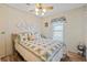 Bedroom includes a comfy bed, ceiling fan, and closet; with wood-look flooring at 772 Imperial Dr, North Port, FL 34287
