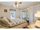 Bedroom includes a comfy bed, ceiling fan, and closet; with wood-look flooring at 772 Imperial Dr, North Port, FL 34287