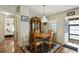 Cozy dining area with hardwood floors, classic furniture, and plenty of natural light at 772 Imperial Dr, North Port, FL 34287