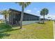Exterior angle of home with enclosed porch, offering a private outdoor retreat at 772 Imperial Dr, North Port, FL 34287