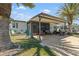 Exterior view of home featuring covered parking, seating area, and golf cart at 772 Imperial Dr, North Port, FL 34287