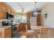 Traditional kitchen featuring wooden cabinets, stainless steel oven, and a cozy breakfast nook with seating at 772 Imperial Dr, North Port, FL 34287