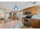 Charming kitchen with wooden cabinets, stainless steel appliances, and a cozy dining area at 772 Imperial Dr, North Port, FL 34287