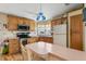 Bright kitchen with wooden cabinets, stainless steel oven, and adjacent breakfast bar with seating at 772 Imperial Dr, North Port, FL 34287