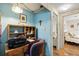 Home office area with a desk, chair, and a view of the adjacent bedroom at 772 Imperial Dr, North Port, FL 34287