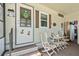 Inviting front porch with seating area creating a cozy welcome at 772 Imperial Dr, North Port, FL 34287